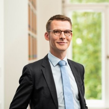 Lawyer Valentin standing in front of the house entrance