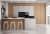 Moderne Küche mit Holz- und Beton-Optik, Kücheninsel mit Barhockern, integrierte Backöfen und Kochfeld.